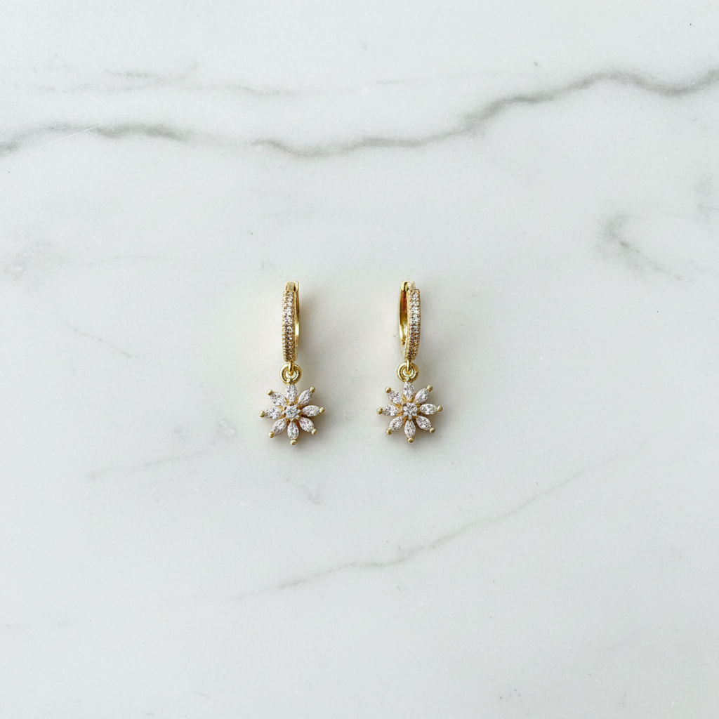 Crystal daisy flower hoop earrings flat lay on white marble