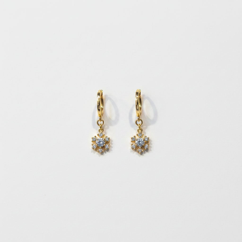 Crystal flower drop earrings flat lay on white surface