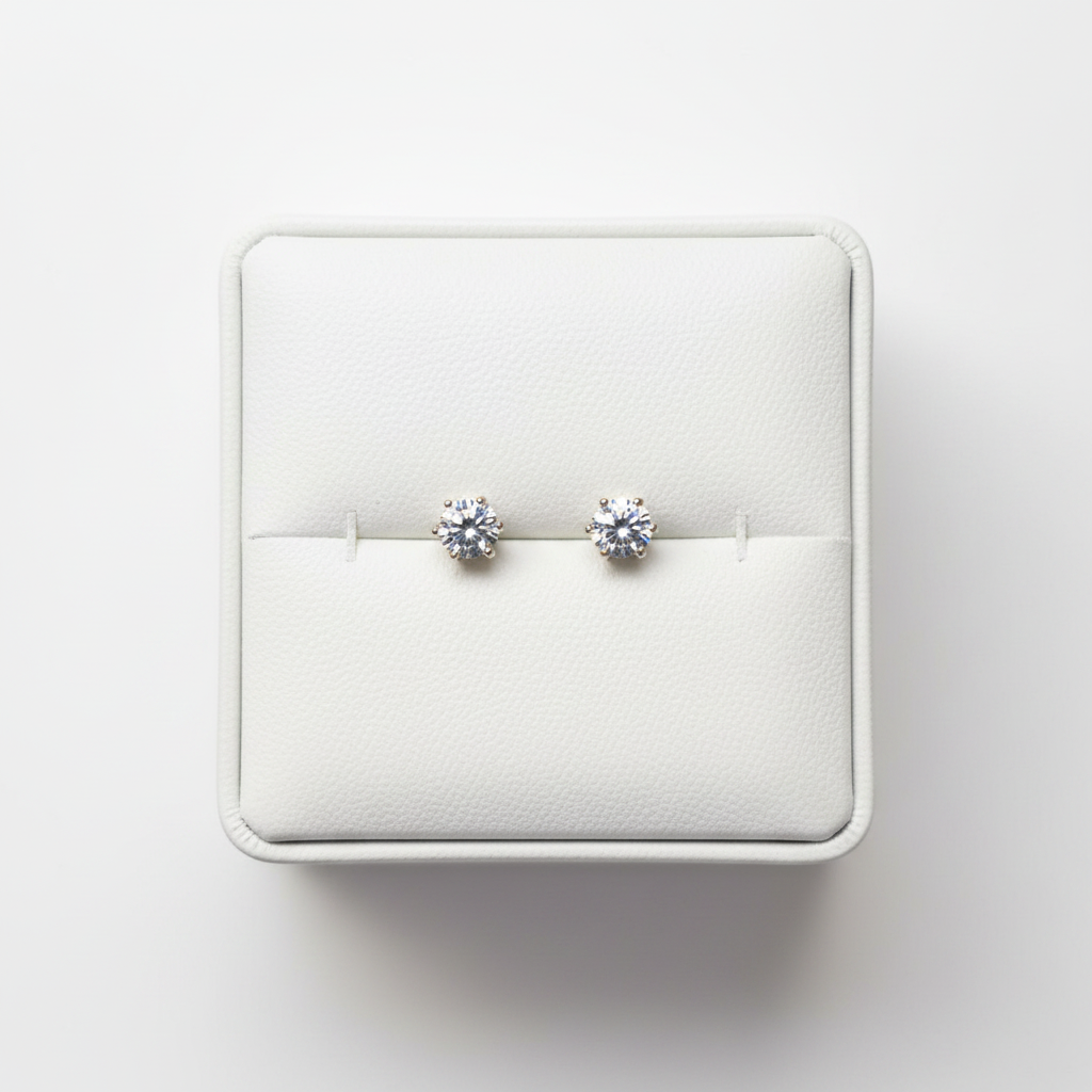 CZ solitaire stud earrings on white jewelry box