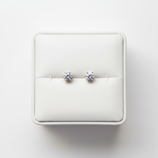 CZ solitaire stud earrings on white jewelry box