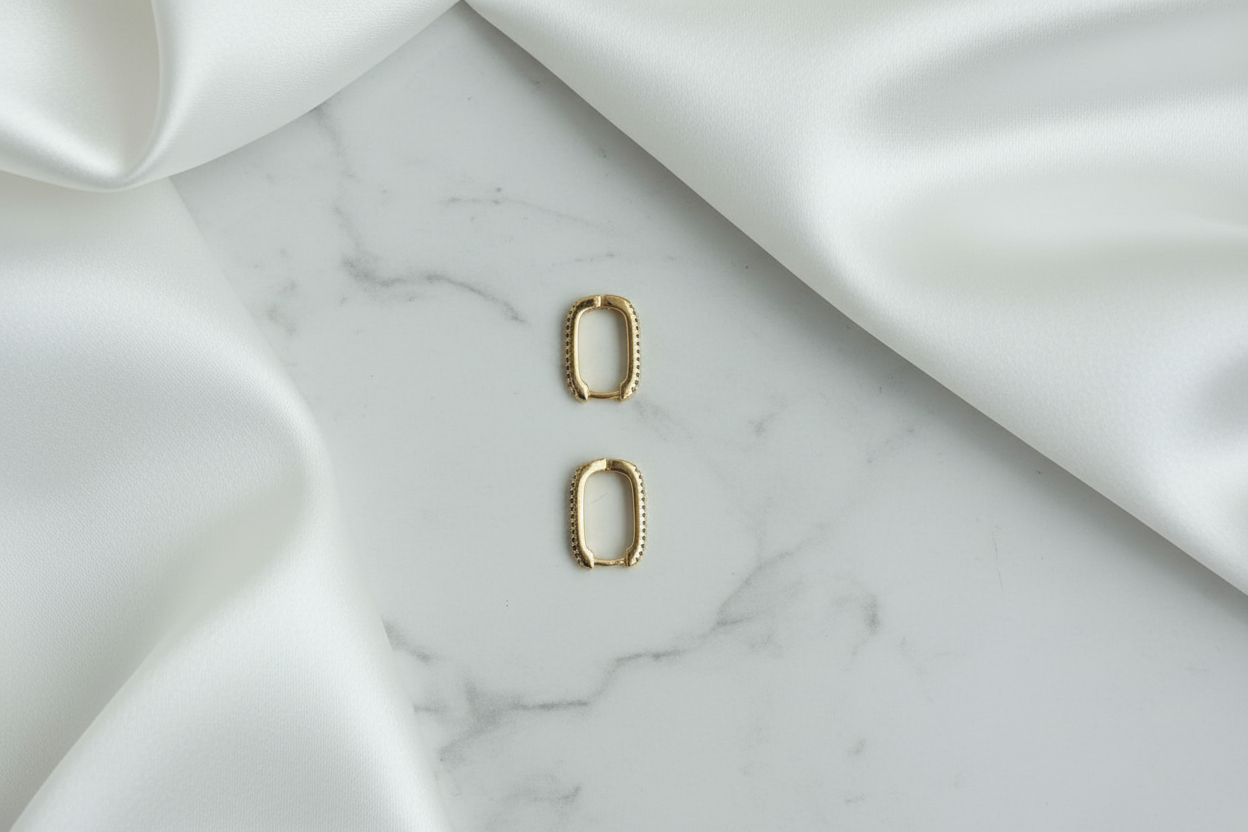 Adelia Huggies pavé CZ rectangular huggie earrings on white satin marble