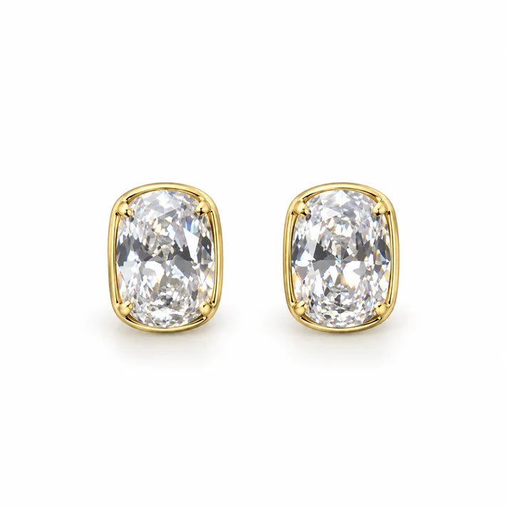 Pair of clear cushion-cut rectangular stud earrings in gold-tone settings on white