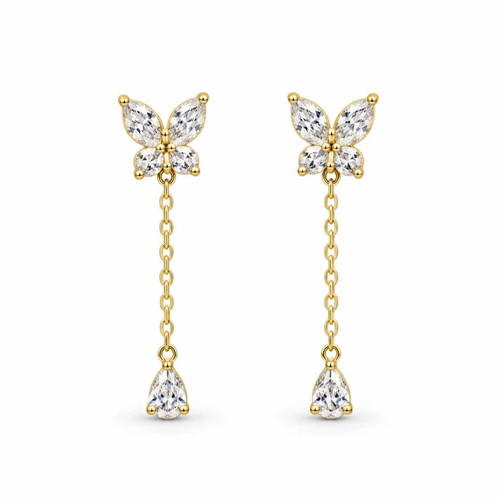 Pair of gold-tone butterfly drop earrings with clear stones, chain drops and pear-shaped pendants on white
