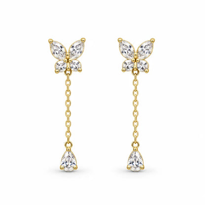 Pair of gold-tone butterfly drop earrings with clear stones, chain drops and pear-shaped pendants on white