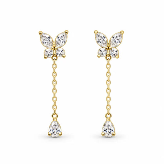 Pair of gold-tone butterfly drop earrings with clear stones, chain drops and pear-shaped pendants on white