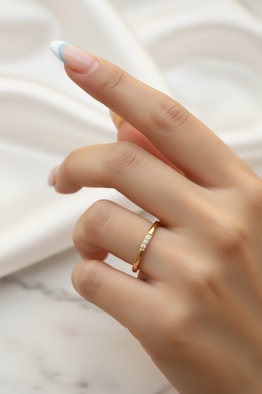 Lumora Ring on raised hand with white satin marble background