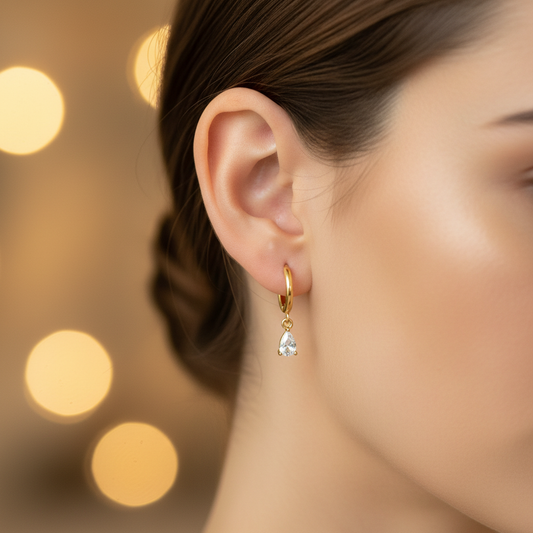 Darcy Huggies teardrop CZ huggie earring close-up on model ear