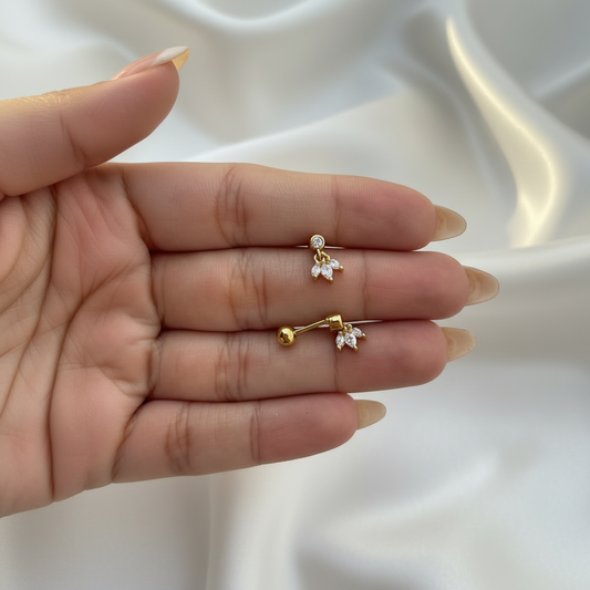 Gold Lotus Petal CZ Drop Studs with nude almond nails on white satin background