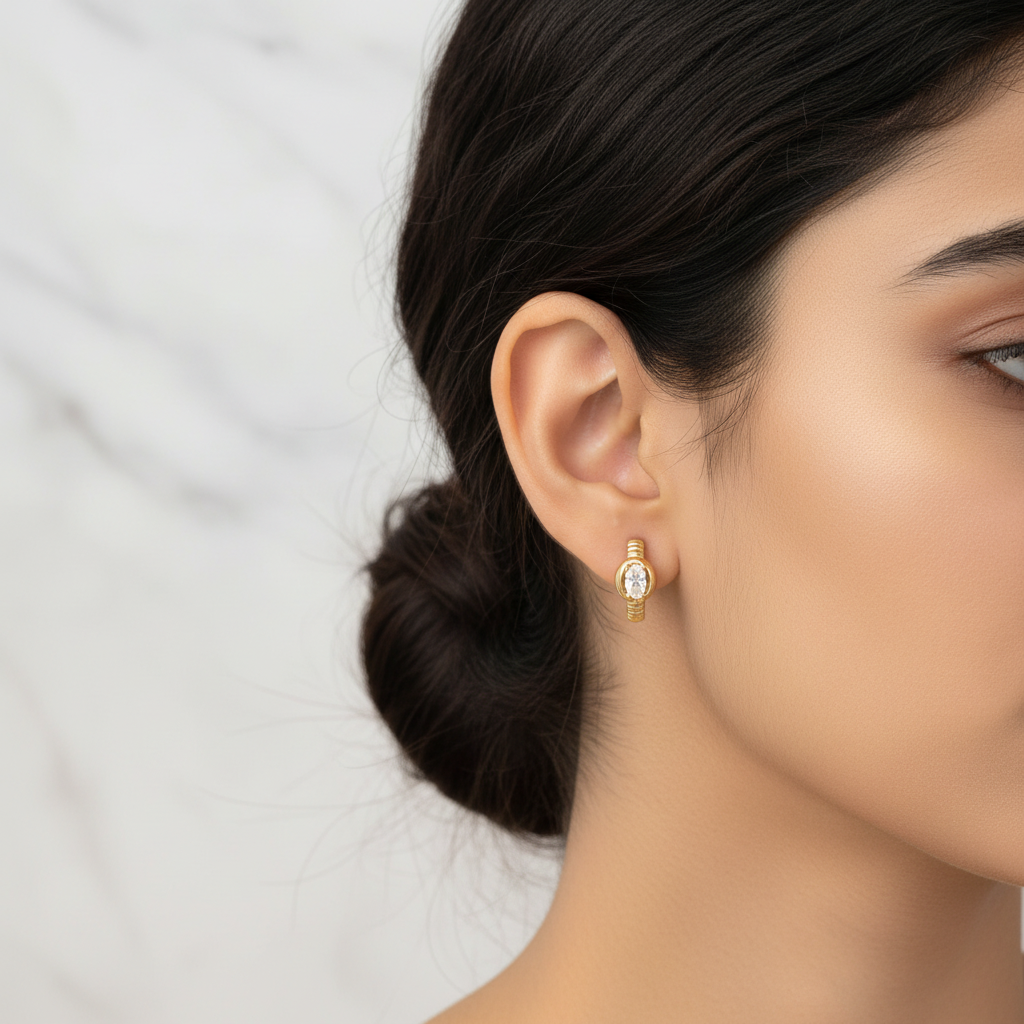Victoria Huggie oval CZ earring worn on model ear