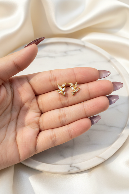Aurora Leaf Cluster Studs on elegant hand marble background