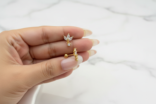 Lara Crown Studs on white marble background editorial shot