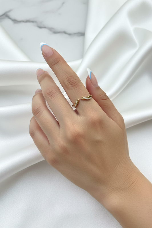 Sera Wave Ring on raised hand against white satin marble backdrop