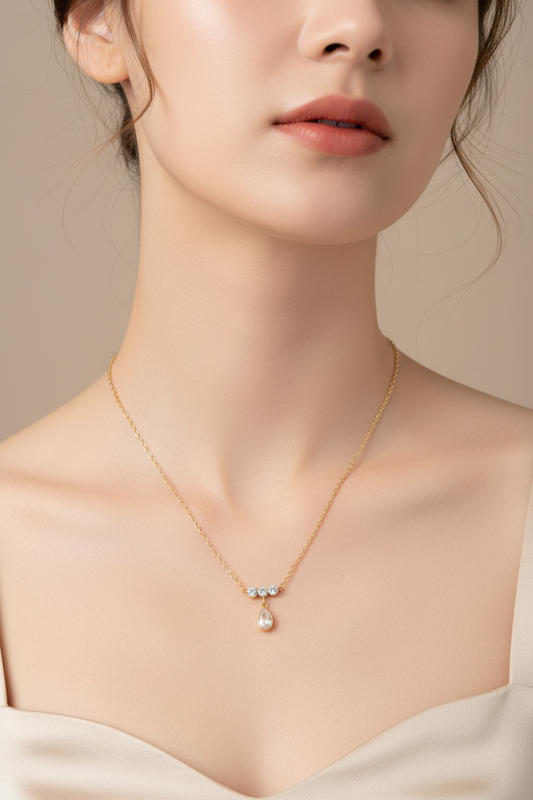Triple Diamond Teardrop Gold Necklace worn on model neck