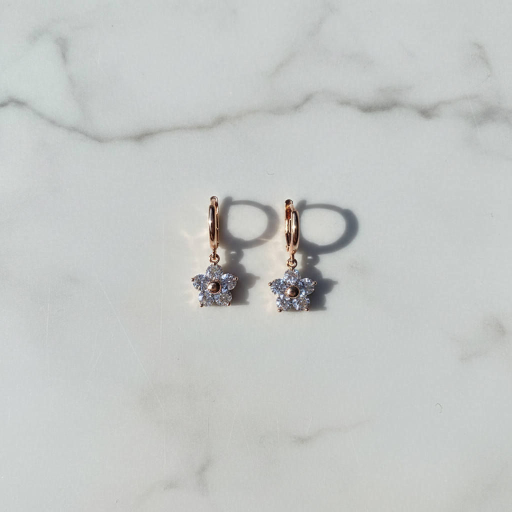 Crystal flower drop earrings flat lay on white surface