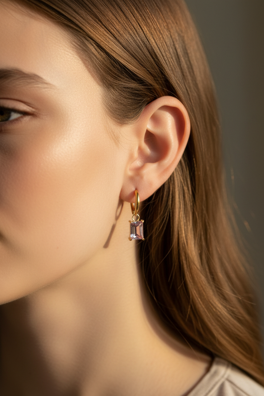 Pink Drop Huggies worn on girl's ear lifestyle shot