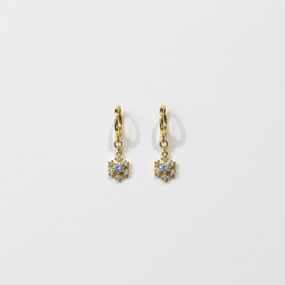 Crystal flower drop earrings flat lay on white surface