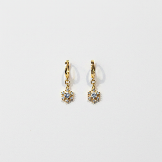 Crystal flower drop earrings flat lay on white surface